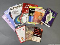 All 11 books and magazines laid out overlapping