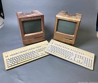 Front view of two Macintosh Classic II computers and two keyboards