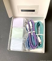 Open box showing three wrapped wall chargers and two visible braided cables
