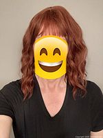 Person wearing the red wavy mid-length wig