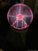 Plasma globe energized showing pink and blue plasma filaments