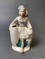 Front view of ceramic lady pocket vase showing floral decoration and main vase opening