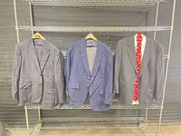 All three jackets hanging on rack