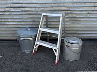 Ladder standing with both buckets showing size comparison and lids