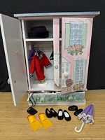 Wardrobe open showing painted exterior, interior, hangers, shoes, umbrella, flippers