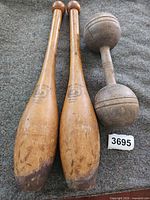 Pair of Spalding Indian clubs and wooden dumbbell overall view