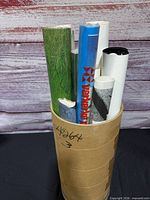 Cardboard tube holding multiple rolled posters