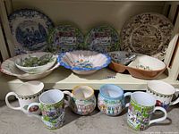 Entire lot showing plates, bowls, server and mugs on shelf