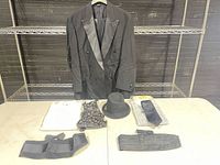 Full lot with jacket on hanger, shirt accessory set on table