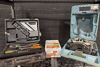Wide shot showing router in blue case, hand tool set in black case, Paslode nail box