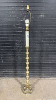 Full view of brass and resin floor lamp