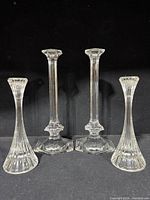 Full set of four crystal candlesticks, tall pair centered, short pair fluted
