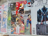 Row of seven bagged Justice League comics