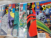 Five comic books laid out partially overlapping