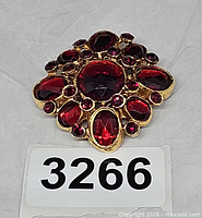 Front view showing red glass stones and rhinestones