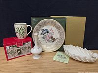 Group shot of Lenox plate, mug, bud vase, decorative bowl, boxes and certificate