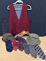 Overall lot showing vest, ties, hats, hangers and tie rack