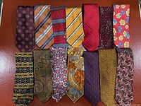 Fourteen ties laid flat showing full pattern assortment