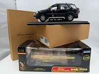 Both model cars with packaging; Mercedes on display stand, Thunderbird in window box
