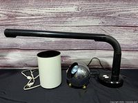 three lamps side by side: desk, cylinder, sphere