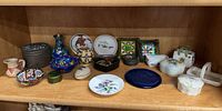 Full shelf view showing entire assortment of trinket boxes, bowls, plates and vase