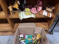 Shelf with four plastic horses, striped cushions, pink vanity, wicker seats