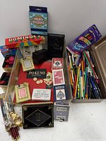 Overall lot view showing playing cards, PO-KE-NO set, dominoes, poker chips, colored pencils and loose writing instruments