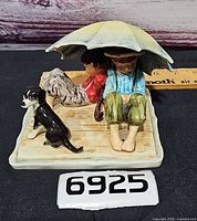 front view children under umbrella with dog