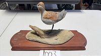 full frontal view of resin sandpiper figurine on wood base