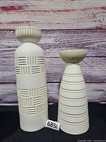 Front view of both vases showing design details