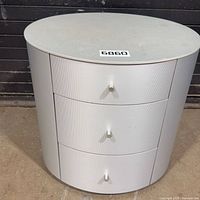 Front view of round silver-gray 3-drawer cabinet