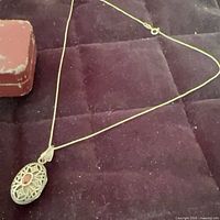 Full view of the sterling silver box chain necklace showing filigree pendant and clasp