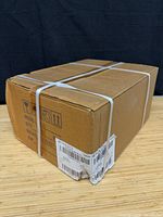 Sealed cardboard shipping carton with plastic straps
