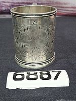 Front view showing floral engraving and inscription