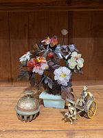 Group view of three items: flower tree, censer, rickshaw