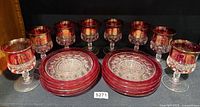 Full lot view showing 8 goblets and 8 plates in cranberry and clear pressed glass