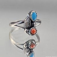 Front view showing turquoise and coral stones, leaf accent, split shank
