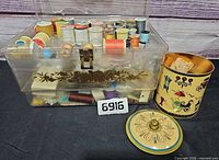 overall view of sewing box, spools, metal tin and lid