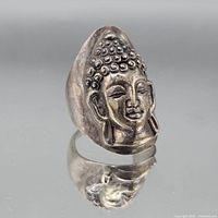 Front view showing Buddha relief design and overall patina