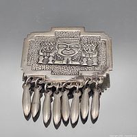Front view showing raised tribal design and six dangling drops