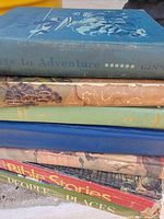 Stack of six vintage children’s books showing spines and covers