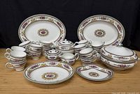 Full lot showing cups, platters, teapot, sugar bowl, creamer, tureen