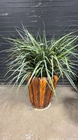 Full view of wicker planter with faux plant