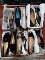 Overview of six shoeboxes containing all shoe pairs