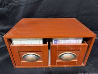 Front view of two-drawer CD box, drawers partly open showing metal cup pulls