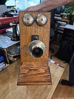 Front view showing oak case, dual bells, mouthpiece, handset and shelf