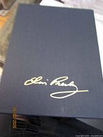 Navy cloth slipcase with gold Elvis Presley facsimile signature