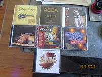 All seven CDs laid out showing front inserts