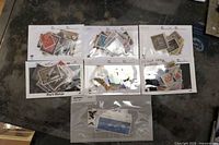 All seven stock cards and sleeve laid out
