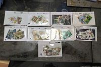 Nine stock cards of Kenya stamps laid out